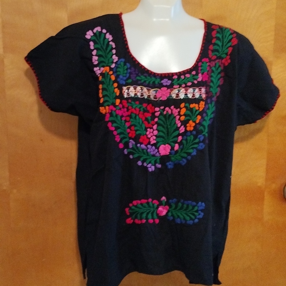 Typical embroidery colors black blouse from Oaxaca.